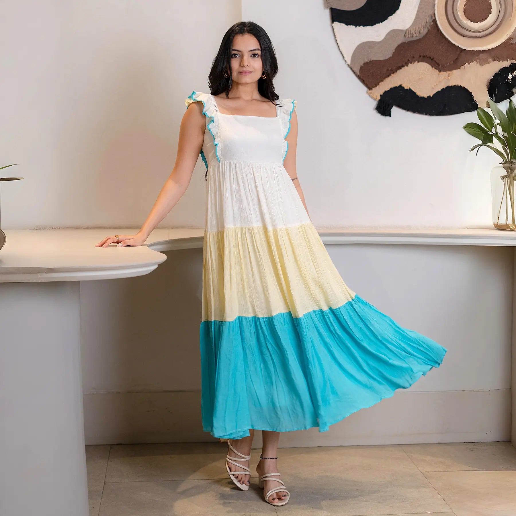 Long maxi dress with flared hem captured in side-flow pose, ideal for beach outings.