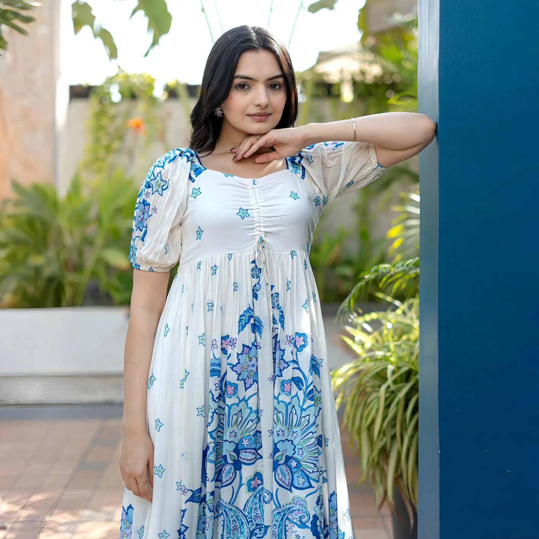 Close-up view showing puffed sleeves and floral print, a chic A-line maxi style.
