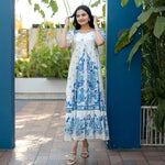 Front-facing pose in a breezy floral maxi dress, ideal for festive functions, birthday and summer evenings.