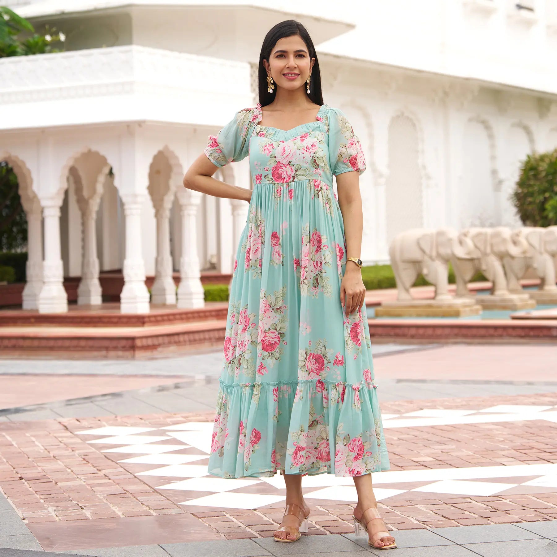 Woman in a floral A-line maxi dress with puff sleeves, perfect for brunches or casual summer outings.