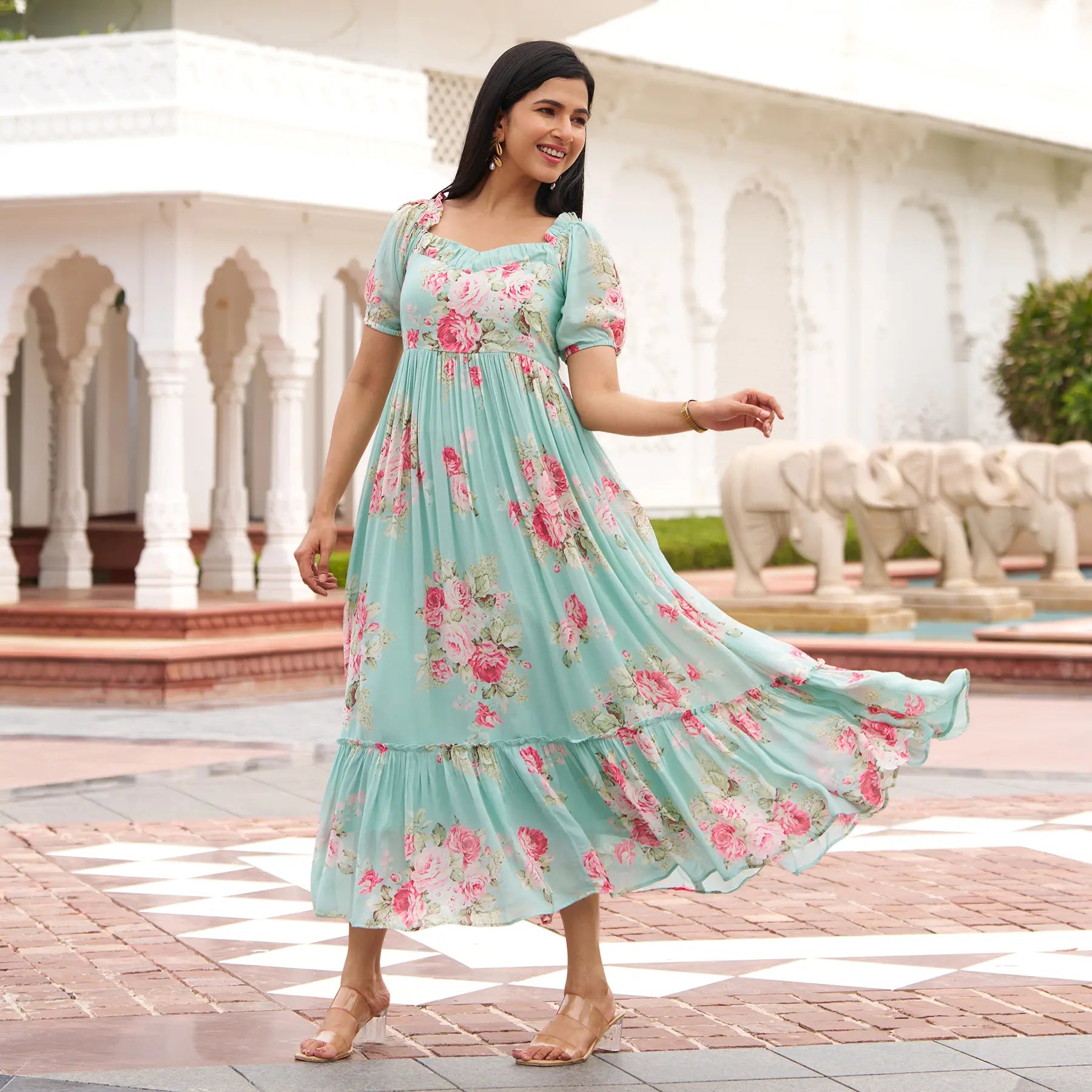 Elegant A-line maxi dress with sleeves in floral print, flowing gracefully and ideal for beach vacations or summer evenings.