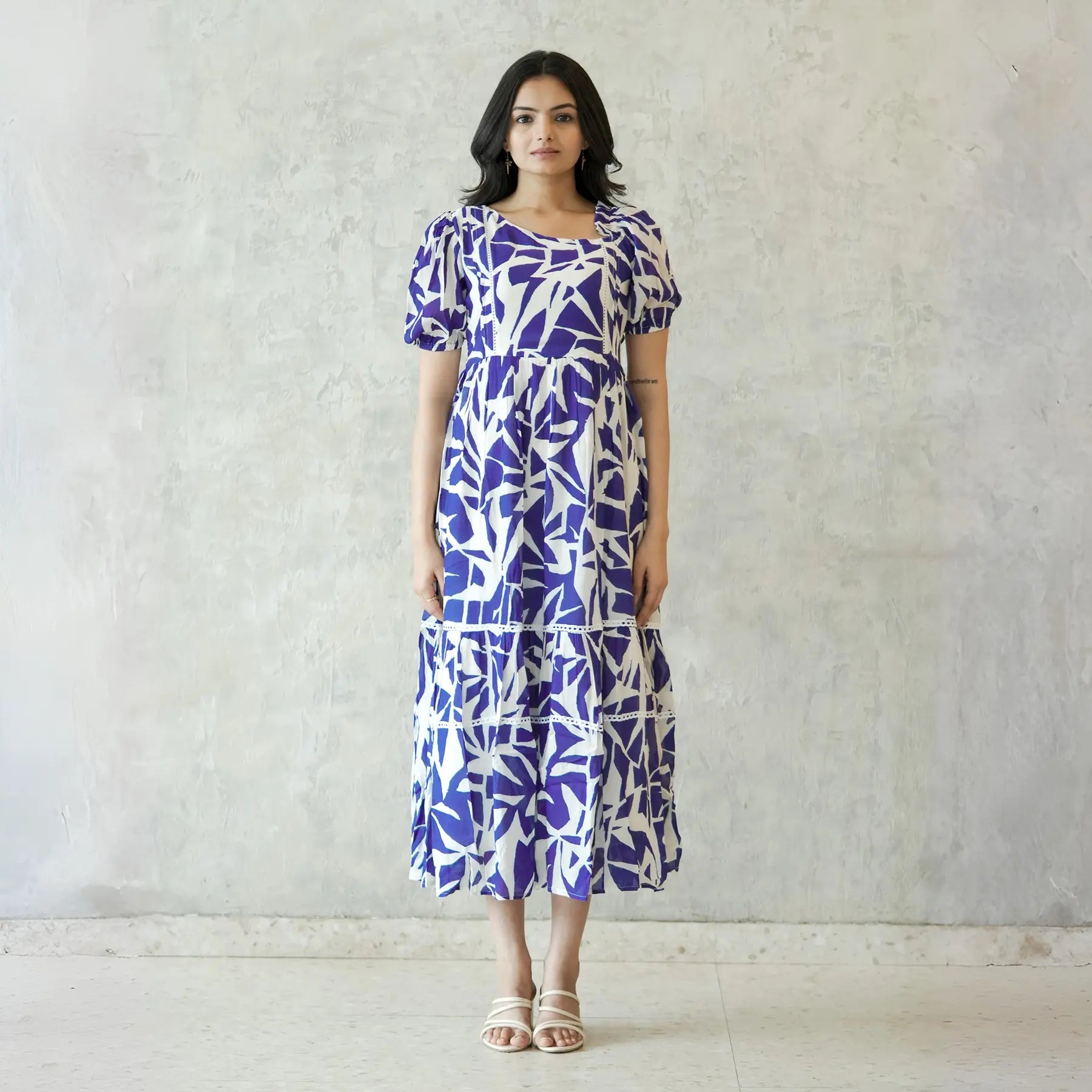 Model in Abstract print midi dress for women with puff sleeves, perfect for a chic summer look.