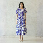 Model in Abstract print midi dress for women with puff sleeves, perfect for a chic summer look.