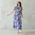 Model walking in A-Line midi dress for women, featuring puff sleeves and flowy silhouette for a relaxed day outing.