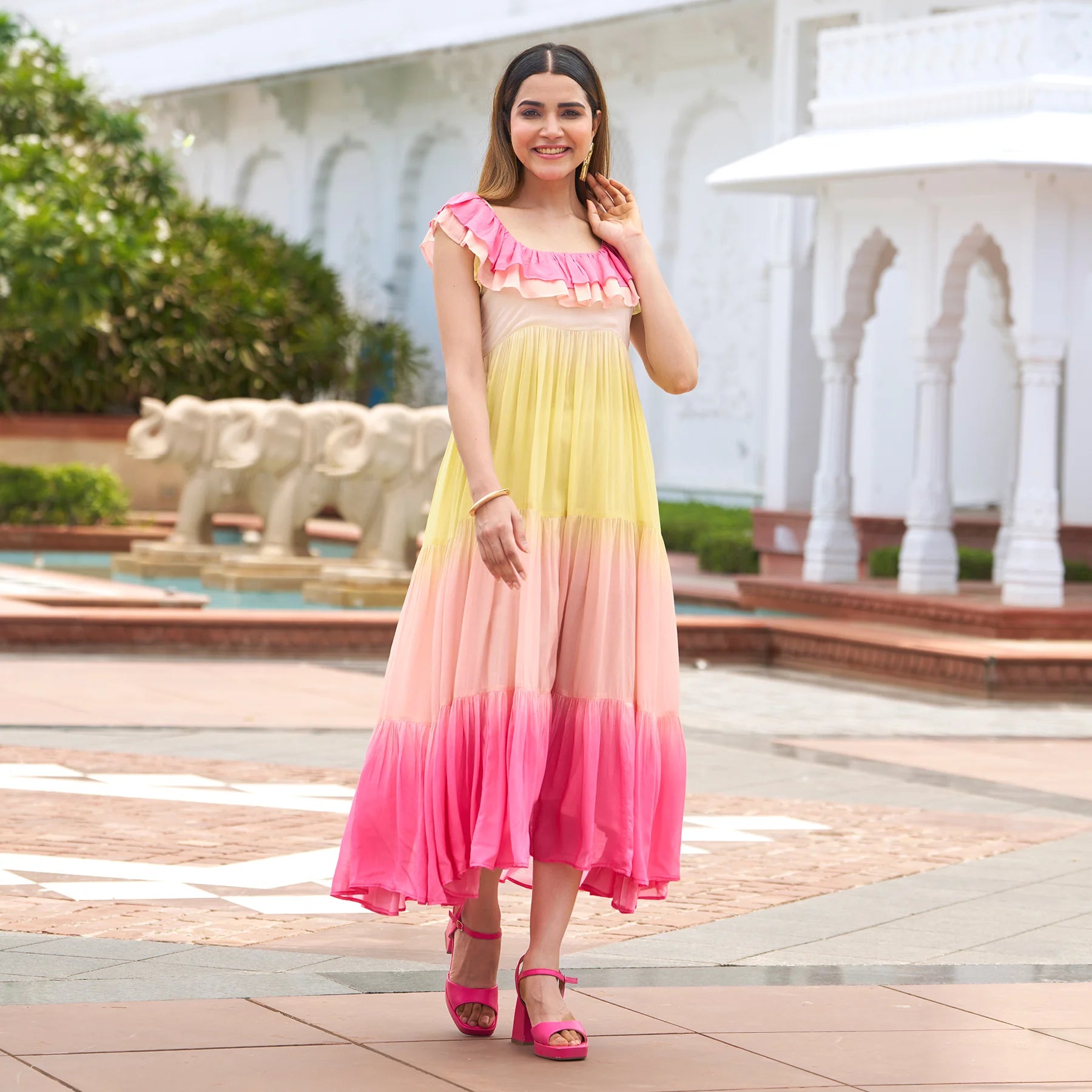 Woman in ColorRush tiered midi dress with ruffled neckline — a vibrant A-line midi dress for women.