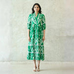 Woman in a green midi dress for women, front view highlighting tiered silhouette and collared neckline.