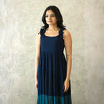 Close-up showing square neckline and shoulder tie detail of a sleeveless midi dress.