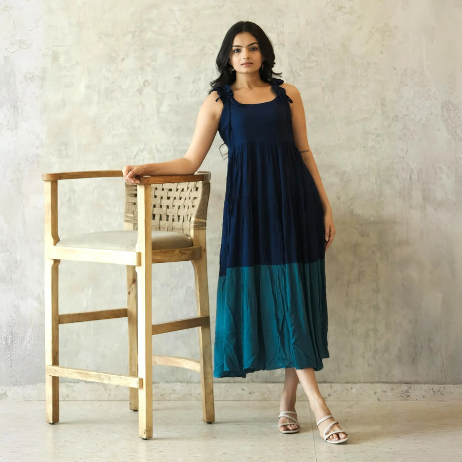 Sleeveless A-line midi dress with a breezy flow, styled casually for brunch or summer outings.