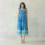 Model wearing blue printed A-line midi dress for women — sleeveless and flowy, ideal as a summer midi dress.
