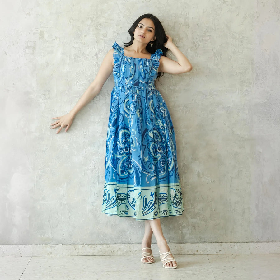 Model leaning in lightweight summer midi dress perfect for brunch or vacations.