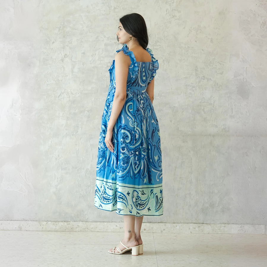 Side view of sleeveless midi dress with ornamental blue patterns — perfect for beach and casual outings.