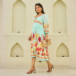 Side walking pose highlighting the puff sleeve midi dress and floral print, perfect for outdoor picnics.