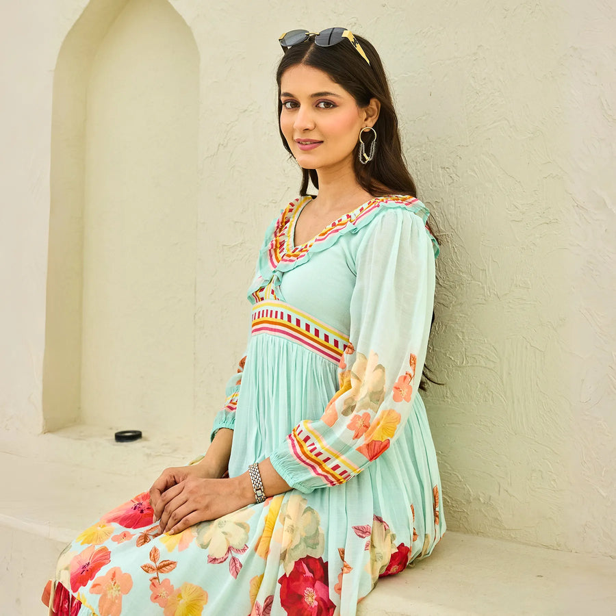 Sitting pose close-up showing neckline and puff sleeve details of the floral midi dress.
