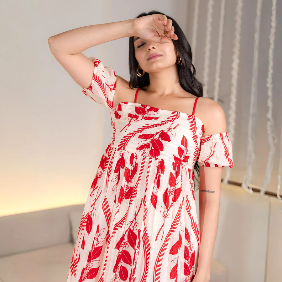 Close-up of red leaf print detailing on a midi dress with a soft A-line flow.