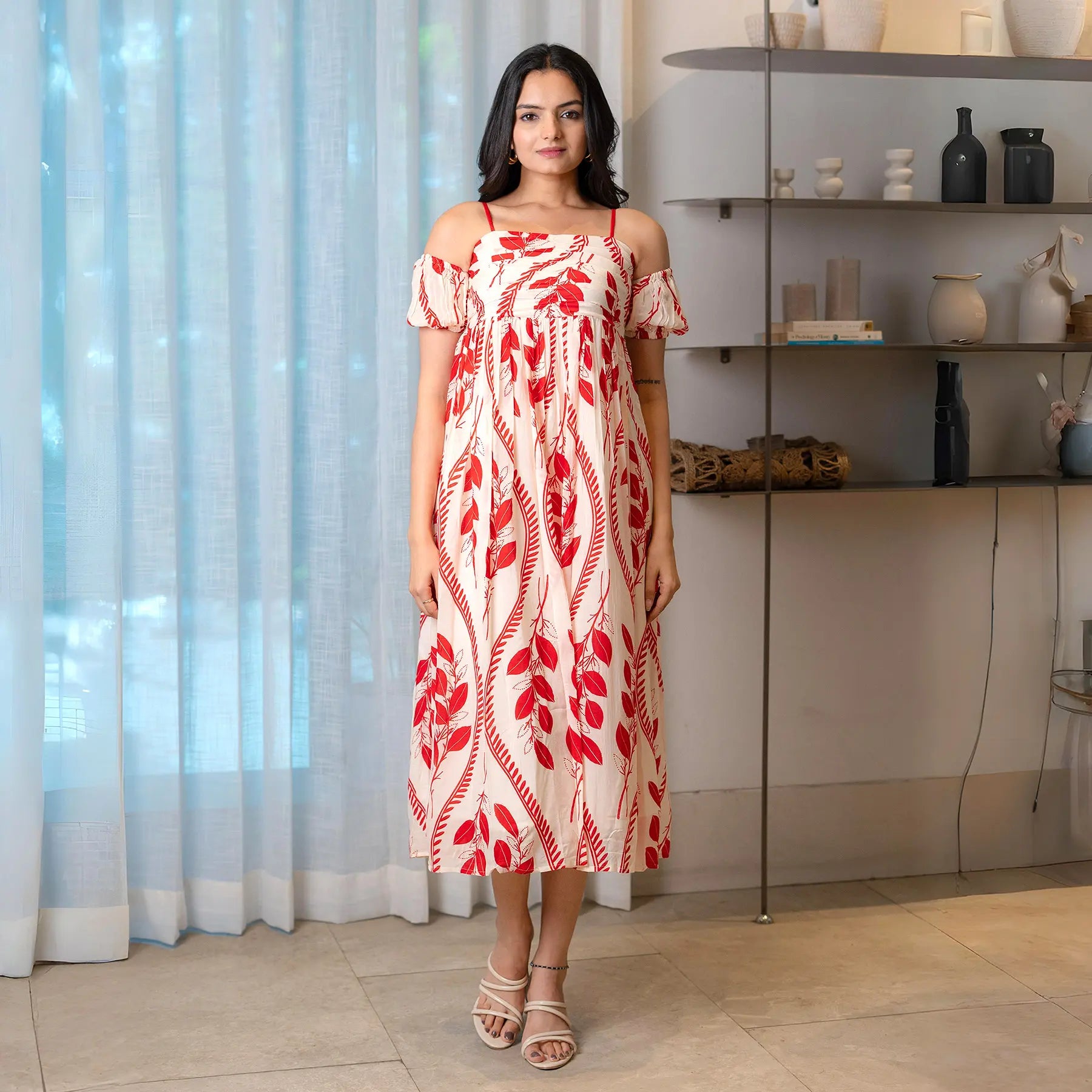 Model in a red leaf print midi dress with cold-shoulder sleeves, styled for brunch or summer outings.
