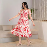 Side view of a breezy A-line midi dress with bold red leaf patterns, perfect for casual celebrations.