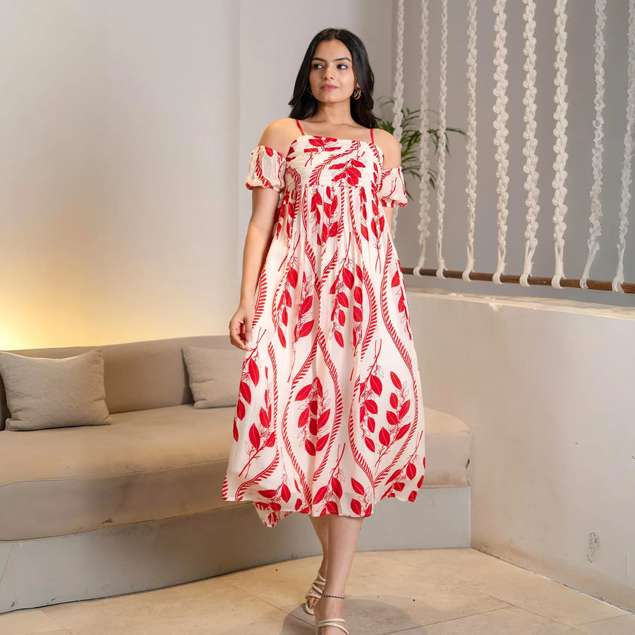 Woman walking in a flowy red print midi dress, a chic pick for vacations and day wear.