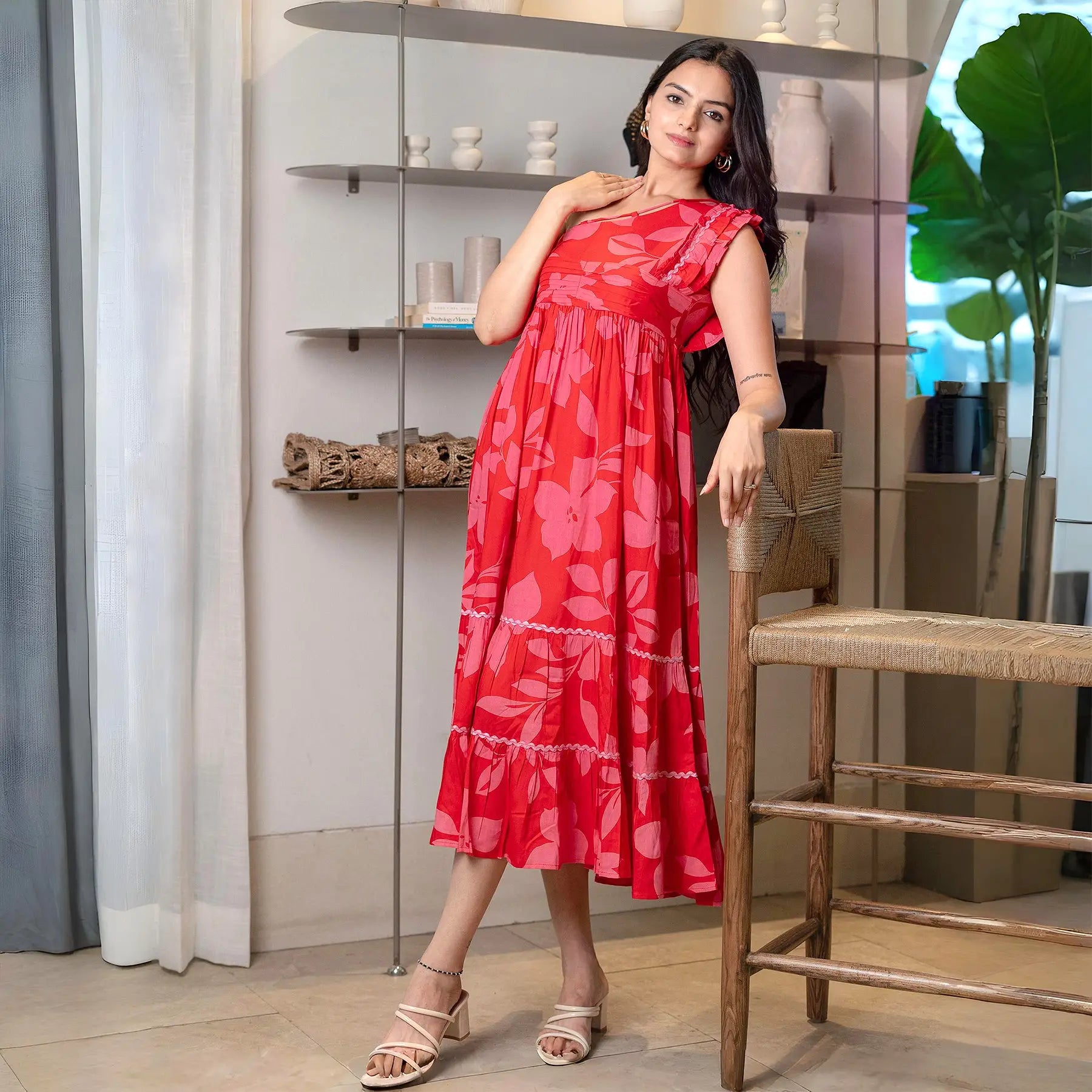 Woman in a vibrant red floral print midi dress with an A-line fit, perfect for summer outings and vacations.
