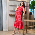 Woman in a vibrant red floral print midi dress with an A-line fit, perfect for summer outings and vacations.