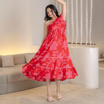 Red floral summer midi dress with an A-line flow, styled for resort wear and brunch dates.