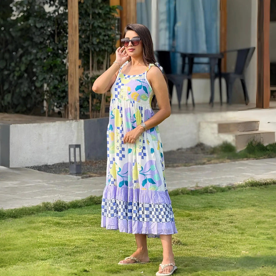 Outdoor lifestyle shot of Tropical midi dress for women, styled with sunglasses on a sunny day in resort.