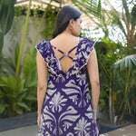 Back view of sleeveless floral A-line dress with cross-strap detail, offering a modern take on long floral dresses.