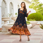Twirling front view of black floral A-line midi dress for women in viscose fabric.