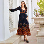 Side view of stylish black midi dress with sleeves – worn by model, soft viscose ideal for vacation.