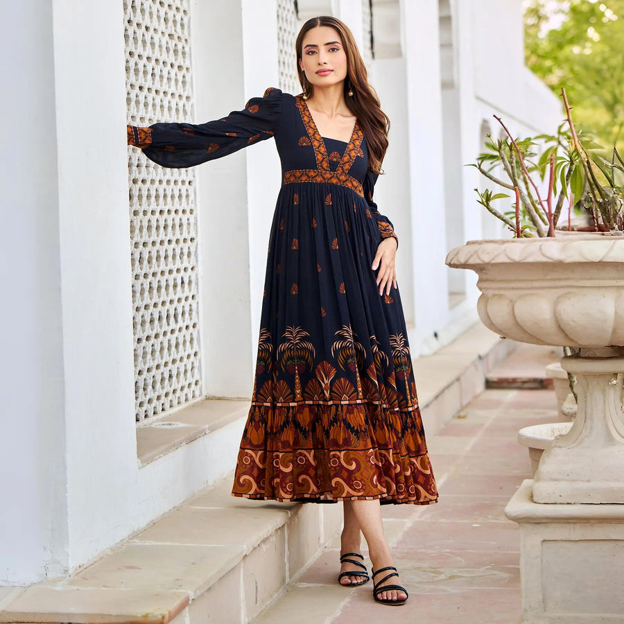 Side view of stylish black midi dress with sleeves – worn by model, soft viscose ideal for vacation.