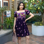 Front casual pose showing a stylish short frock for women with square neckline and floral details