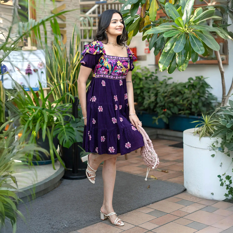 Side smiling pose highlighting a flowy floral frock for women with playful short puff sleeves