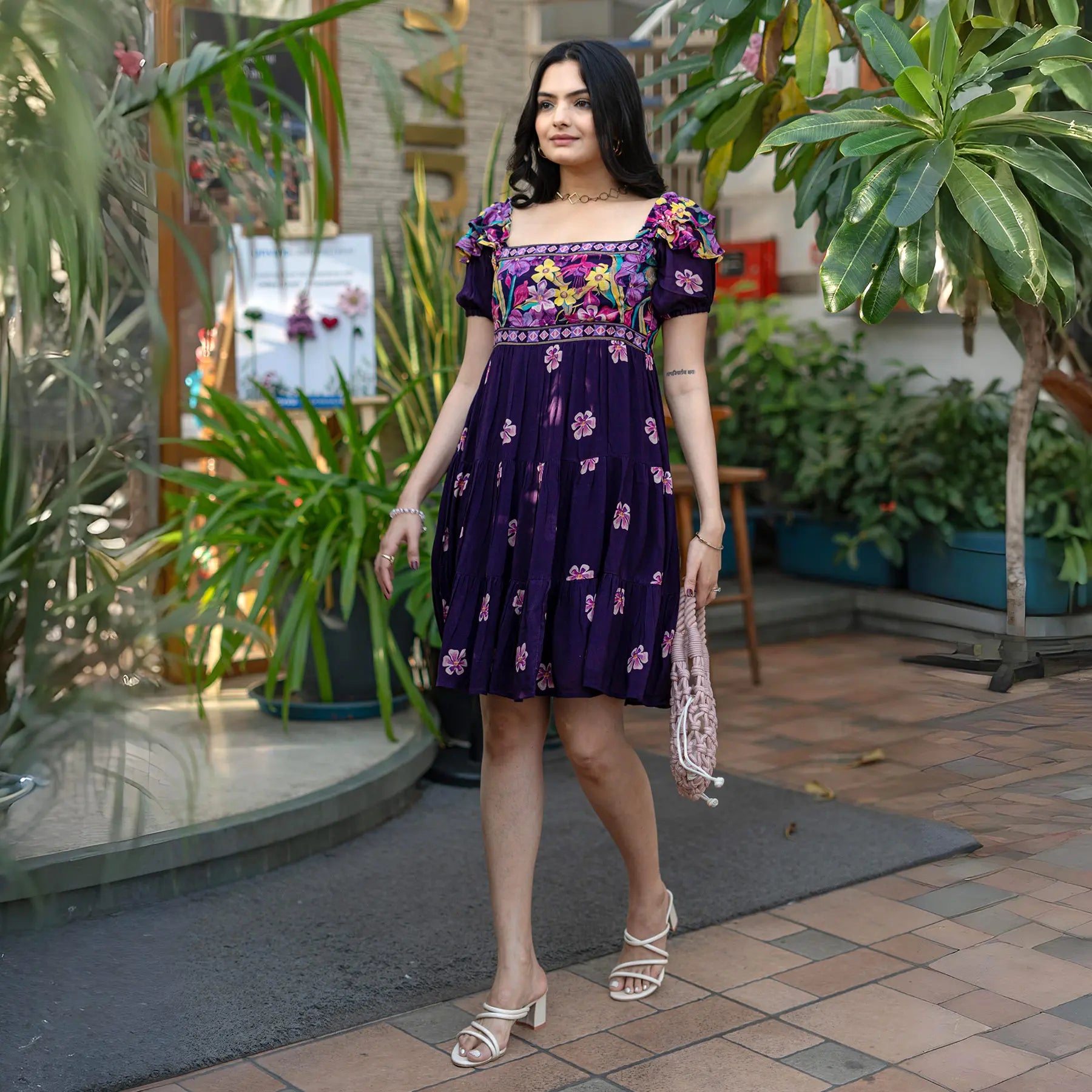 Side walking pose in a chic short dress for women, designed with vibrant floral embroidery for summer outings