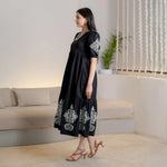 Noir Bloom black cotton long maxi dress features puff sleeves and a graceful drape from the side