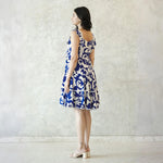 Side view of a ladies short dress, showing a knee length summer style with airy fabric and elegant design