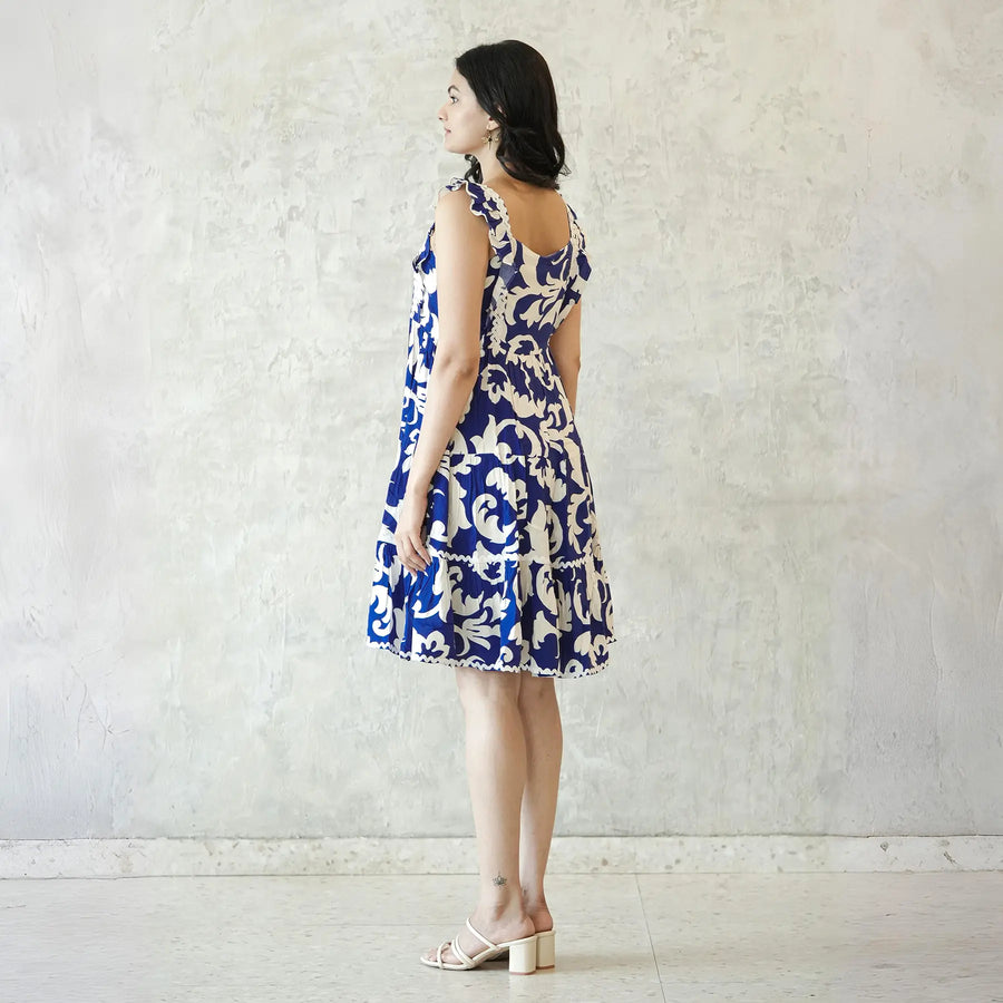 Side view of a ladies short dress, showing a knee length summer style with airy fabric and elegant design