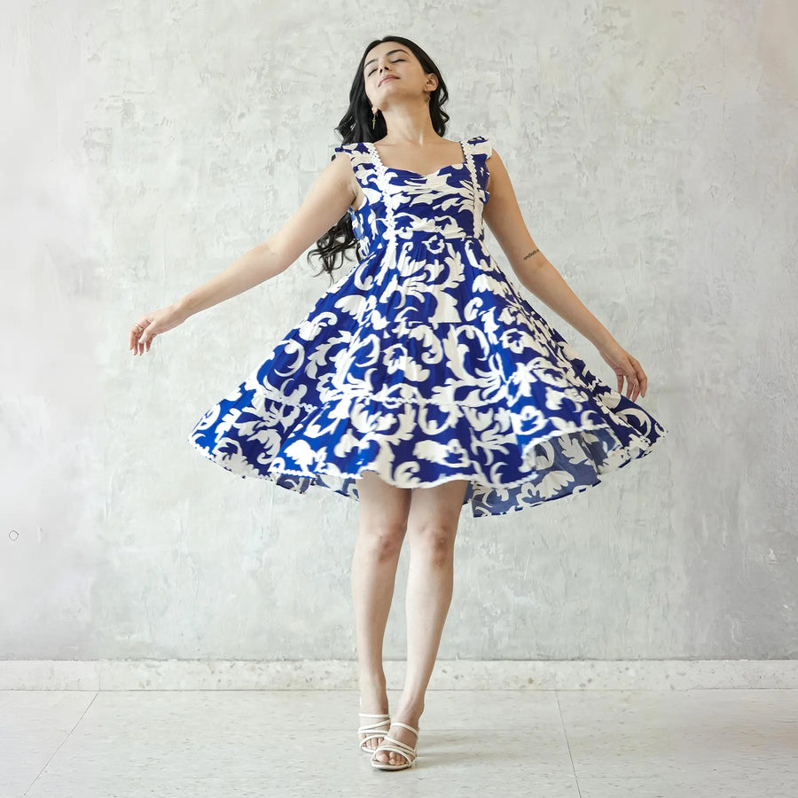 Playful twirl pose in a sleeveless one piece dress, short summer dress ideal for beach outings and casual gatherings