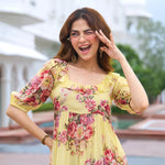 Close-up of floral print and ruffle neckline on pastel midi dress – perfect for summer wear