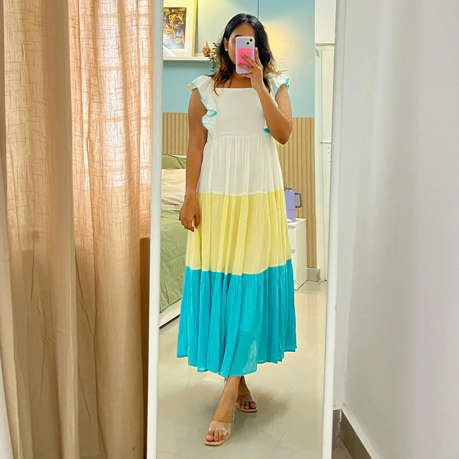 Woman takes mirror selfie in a lightweight, flowy sundress.