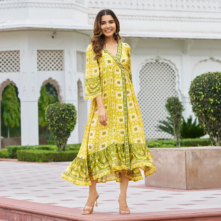 Twirling pose of yellow printed midi dresses for women – perfect Haldi function outfit in viscose