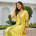 Sitting pose of Haldi function dress – yellow ethnic midi style worn by model, perfect for festive mornings