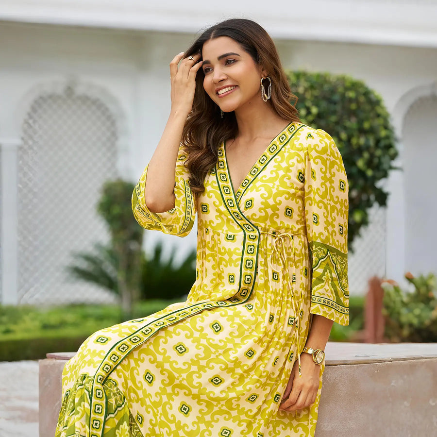 Sitting pose of Haldi function dress – yellow ethnic midi style worn by model, perfect for festive mornings