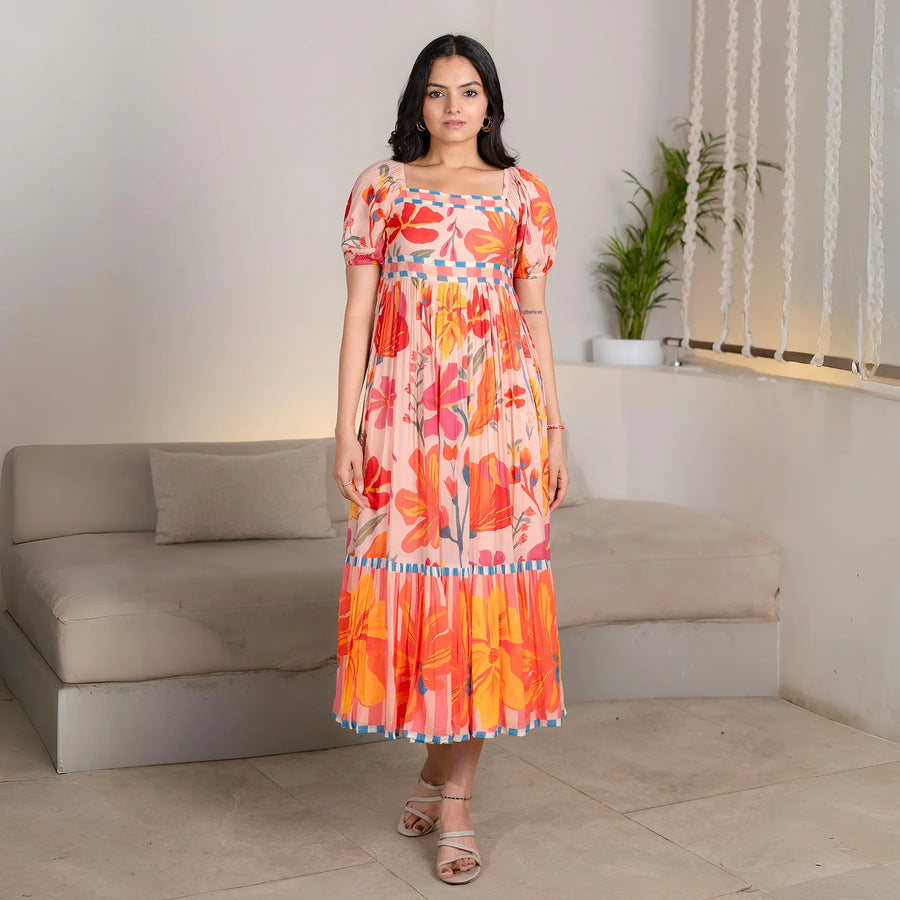 Model wearing Sunset Bloom floral midi dress for women – vibrant summer style in a front view pose.