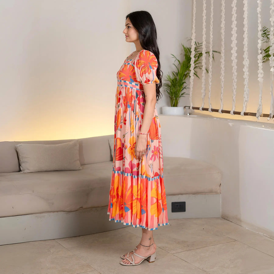 Side view of Sunset Bloom midi dress – lightweight summer dress with puff sleeves and bold floral print.