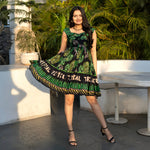 Twirl pose in a playful short frock dress, tropical leaf print designed for summer outings.