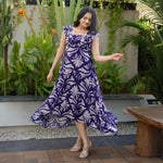 Woman posing in lightweight, flowy floral maxi dress, perfect for brunch or summer outings.