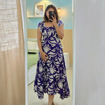 Woman taking a mirror selfie wearing Twilight Bloom floral one-piece dress, breezy and feminine.