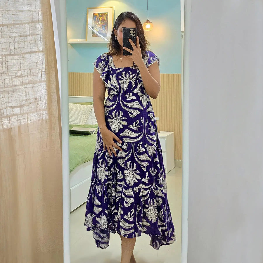 Woman taking a mirror selfie wearing Twilight Bloom floral one-piece dress, breezy and feminine.