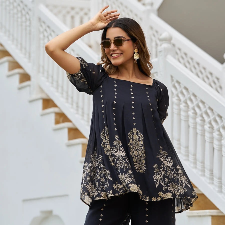 Close-up of black printed co ord dress top with square neckline and ethnic details for festive days.
